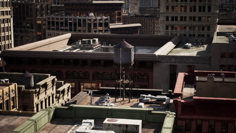 urban rooftops featuring a historic water tower amidst city skyscrapers