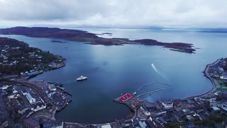 establisher aerial shot of town of oban in scotland with port and ferry, day