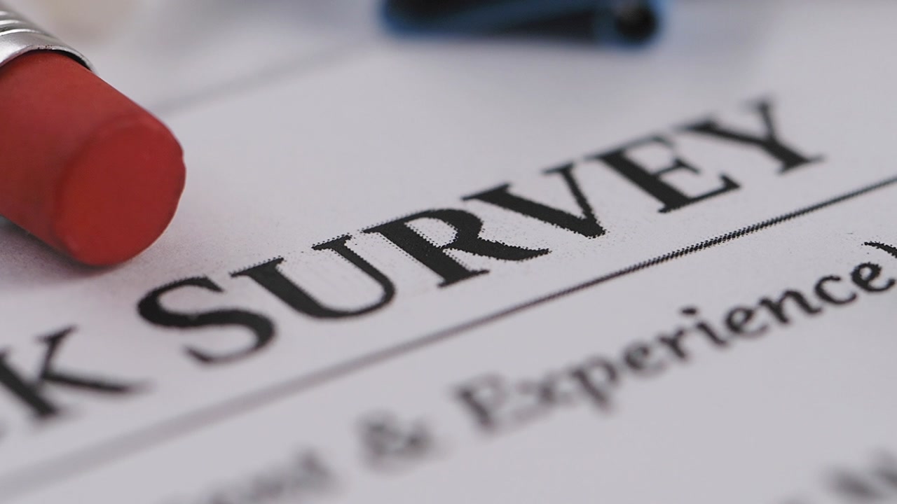 Close-up of Survey Document with Pencil and Office Supplies