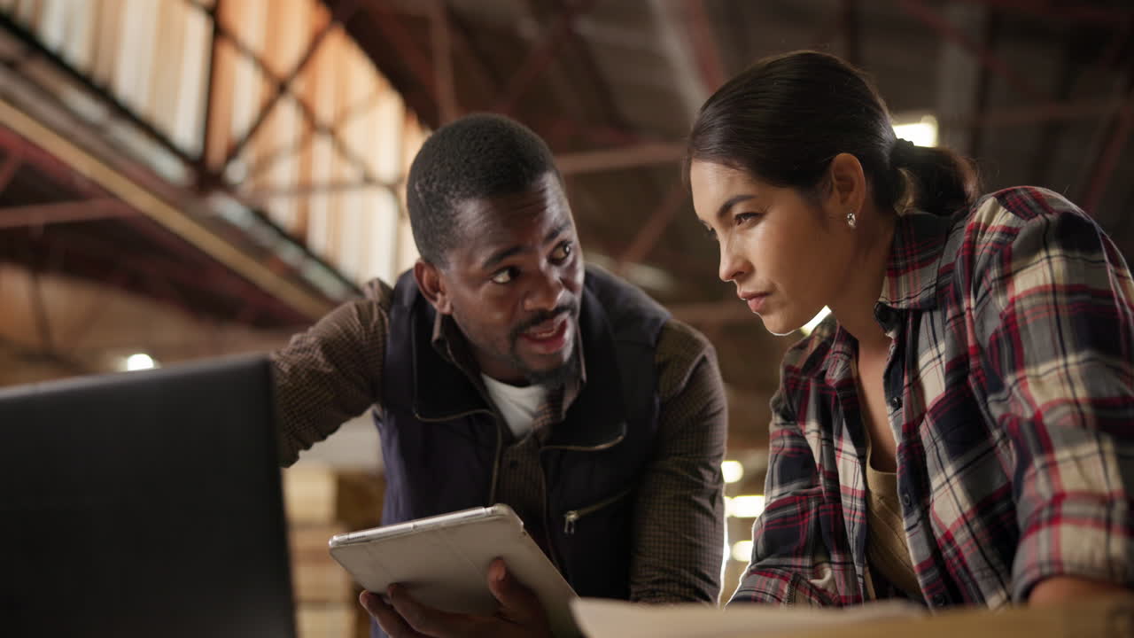 Team working in a warehouse using technology