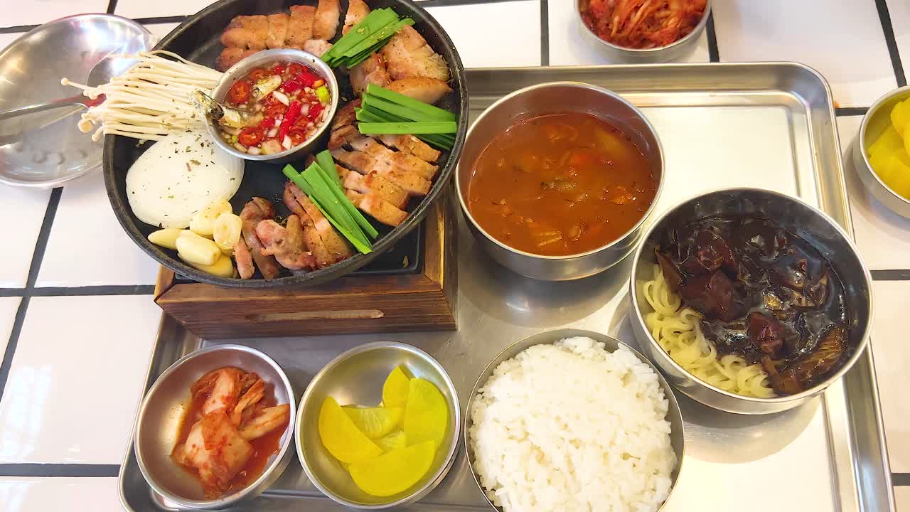 A sequence showing the preparation and arrangement of a traditional Korean meal in a vibrant setting