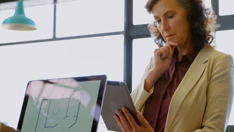 Businesswoman-using-digital-table-in-the-office-4k