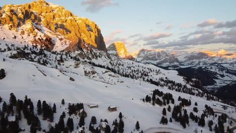 golden hour splashes light on the dolomite mountain range in italy is this panning shot