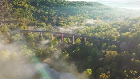 beautiful aerial over a steel railway trestle in the fog in west virginia appalachian mountains 3