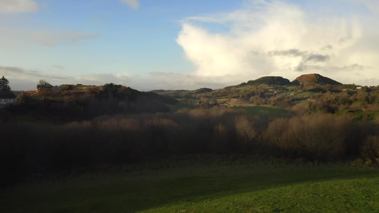 Wintery Irish Rural Landscape, Forkhill, Newry, Northern Ireland. 12 December 2019.  Drone pushes forward over grassy farmland.