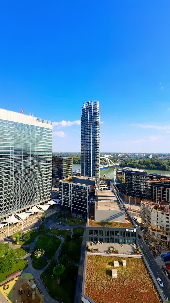 Little cozy green park surrounded by the buildings. Aerial perspective on modern Bratislava, Slovakia. Vertical video.