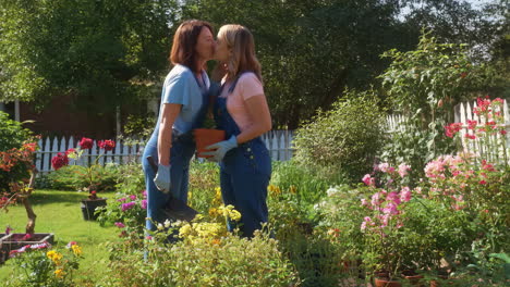 couple gardening and sharing an affectionate kiss in a sunny garden