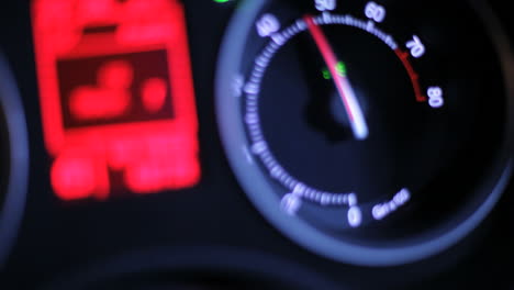 tachometer arrow. car dashboard at night. car rpm. driving fast at night