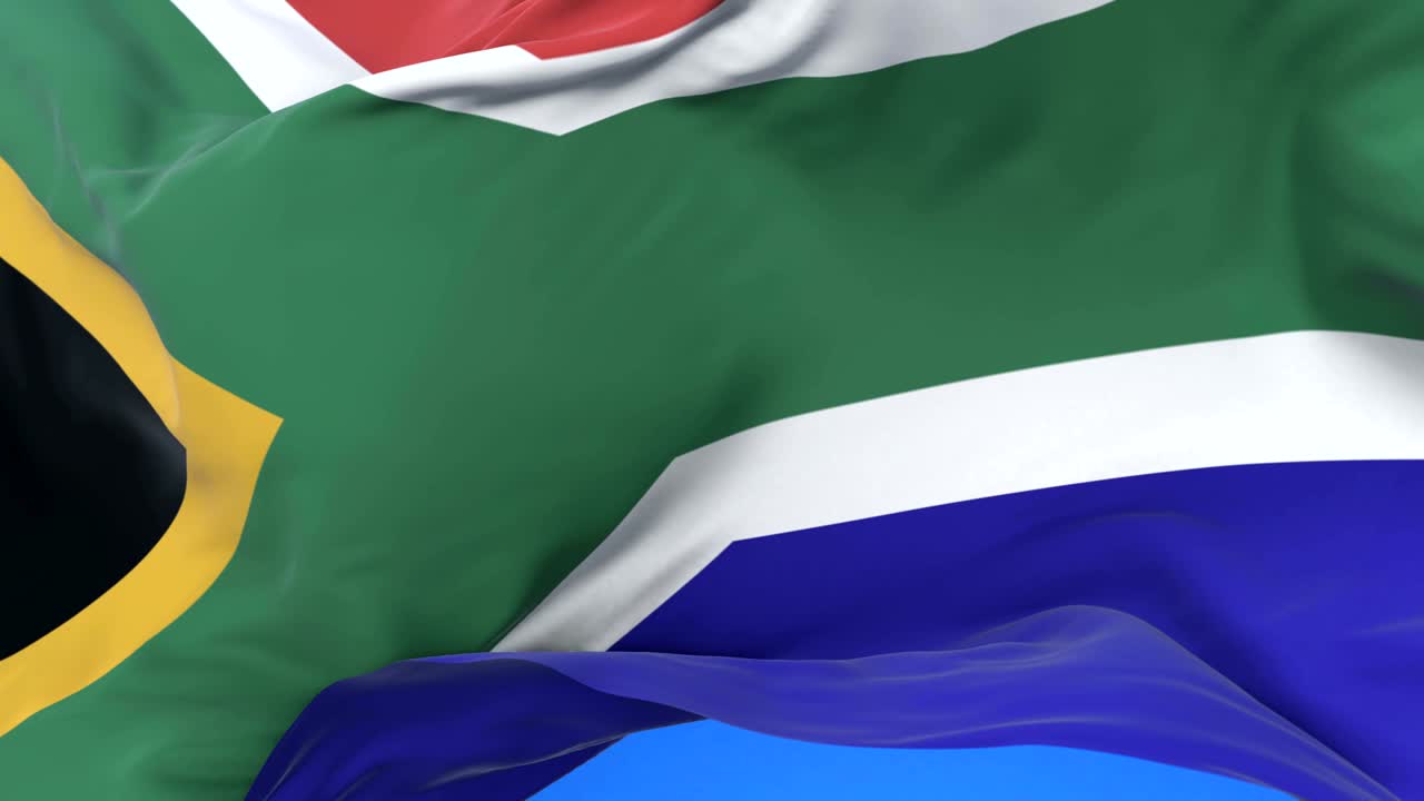 la bandera de sudáfrica ondeando en el viento lentamente en el cielo azul, bucle