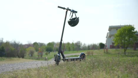 Electric-scooter-with-a-helmet-on-a-bright-background-with-vegetation