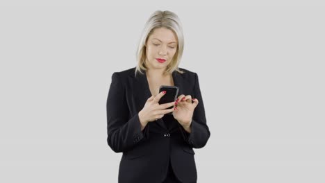 An-attractive-happy-blonde-haired-businesswoman-is-using-an-app-on-her-mobile-cell-phone