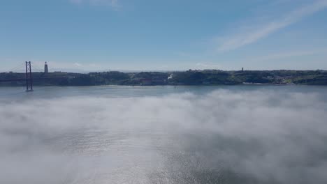 drone shot of the fog over the river in lisbon (portugal).