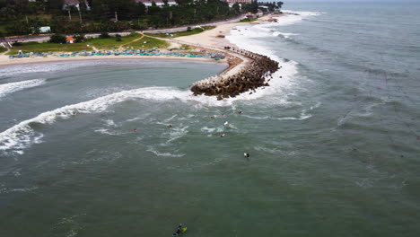 aerial circle view of surfers wait the waves