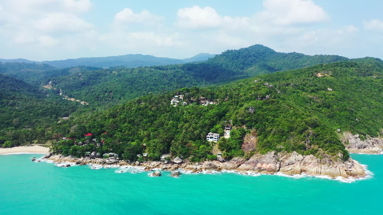 East coast of Koh Phangan, Thailand, Hilled island with palm forest, rocky shore with secluded sandy beaches. Aerial