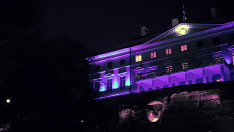 Pan-reveal-of-Stenbock-house,-the-house-of-government-of-Estonia-on-cold-winter-night