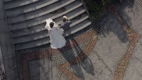 encantadores recién casados novia caucásica novio caminando en el parque, tomados de la mano, pareja de bodas familia