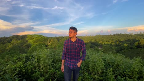 traveler asian man walking confidently in middle of nature tea plantation, dramatic sky