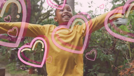 in school, smiling child wearing yellow shirt with animation of pink hearts overlay