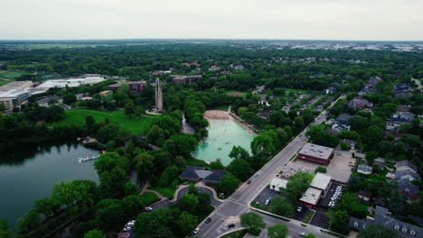 beautiful-overview-aerial-of-Rotary-Park-Sled-Hill,-Moser-Tower,-Millennium-Carillon,-Naperville-Riverwalk-in-DuPage-County