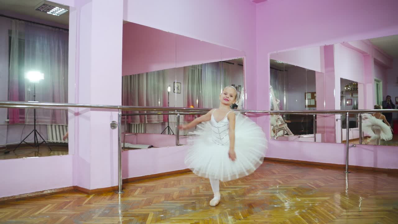 Slow motion. Professional ballerina perform pirouette in the ballet hall. A little dancer.