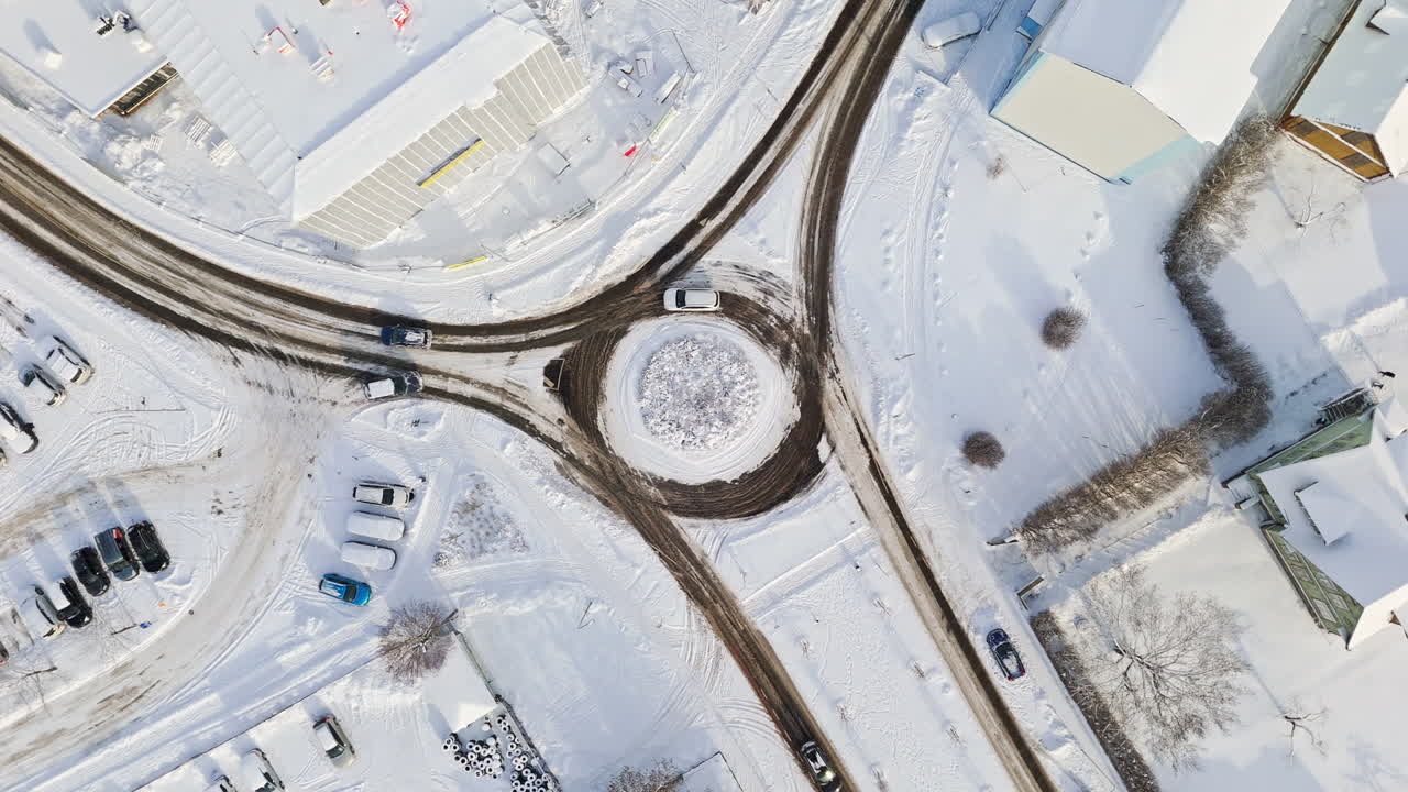 Screwdriver drone shot above traffic in a urban roundabout, winter morning