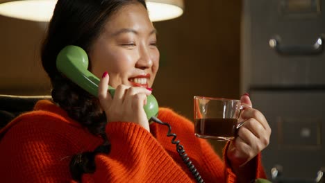 woman on vintage phone with coffee