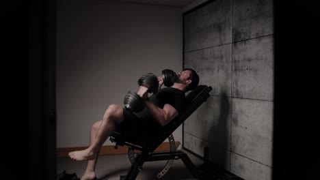 incline dumbbell bench press, cinematic lighting, white man dressed in black gym attire