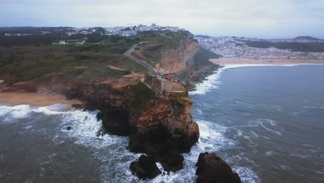 an iconic place on the atlantic coast, the mecca of big-wave surfing. view of nazare's lighthouse in zon north canyon, place with the biggest waves in europe, nazare, portugal