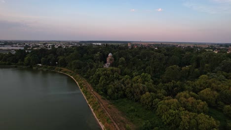 a church amidst the lush stirbey fields at sunset, serene and majestic, aerial view