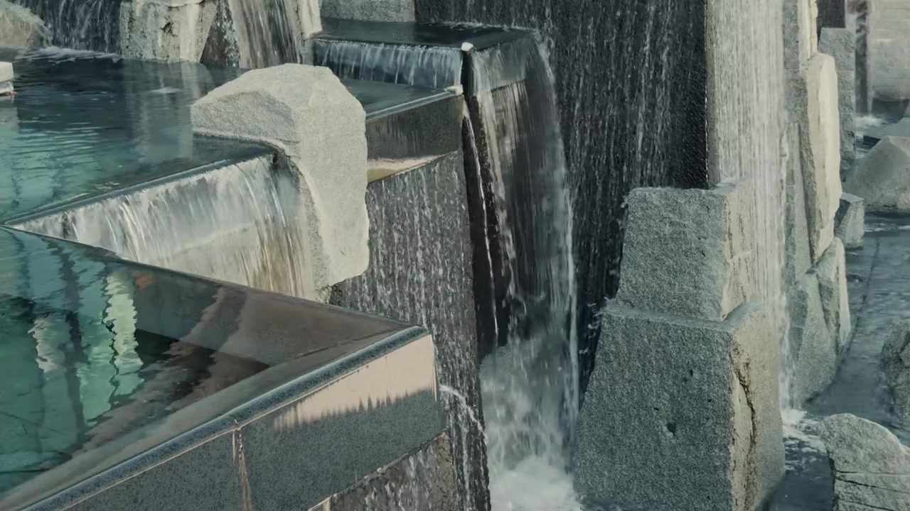 Static view of water cascading across a tiered decorative fountain.