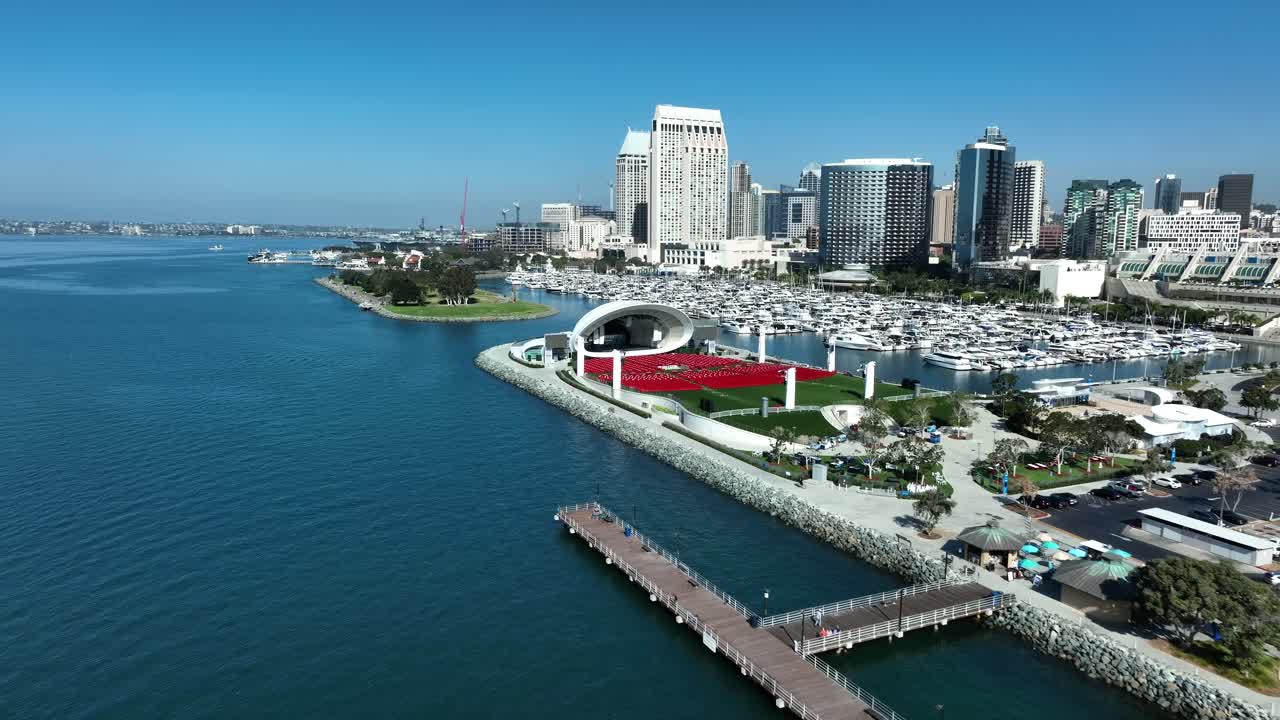 Aerial pullback of Rady Shell, marina and the skyline of downtown San Diego during clear day over the Pacific Ocean