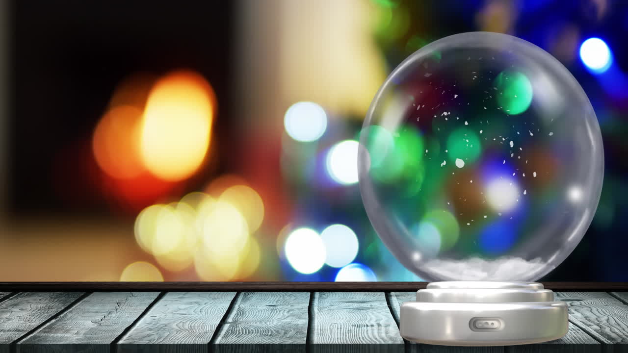 크리스마스 스노우 글로브의 애니메이션으로 크리스마스 요정의 불빛이 배경입니다.