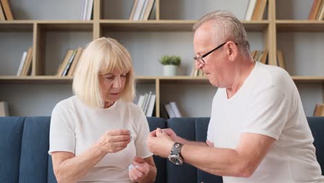 Senior couple discussing medication at home