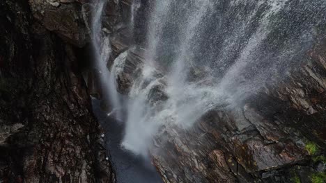 steady drone footage at the bottom of a waterfall