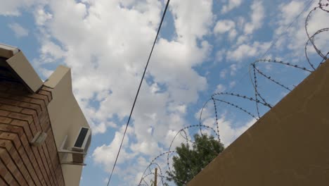 time-lapse-of-barbed-wire-and-a-air-conditioning-unit-with-clouds