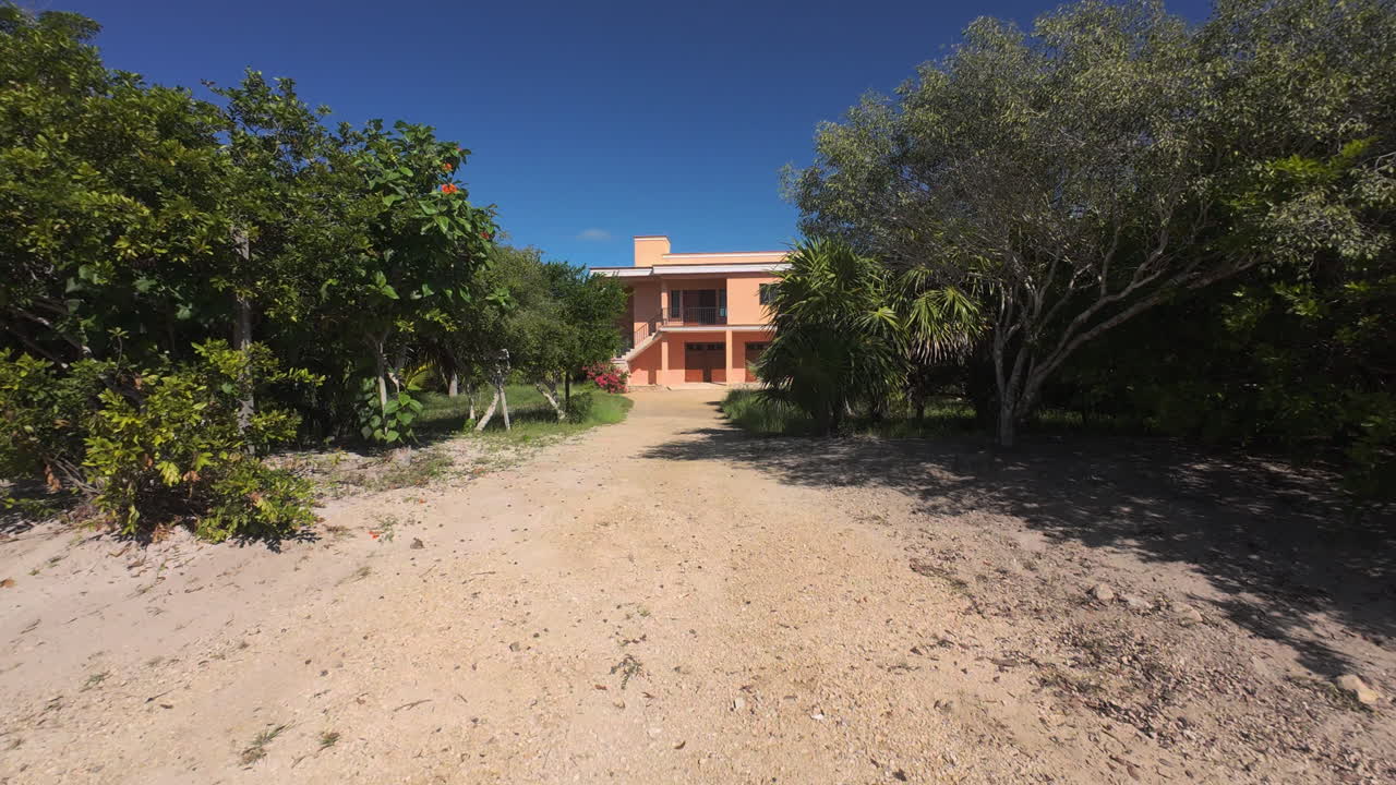 Sisal Travel and Coastal Development. Dynamic video sequence showcasing the vibrant lifestyle and real estate growth in Sisal, Yucatán. Pink house and sand