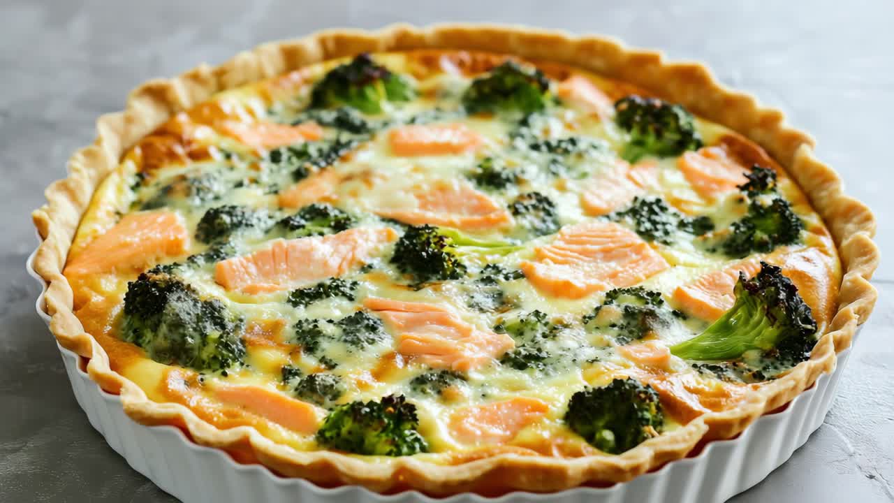 Gourmet quiche featuring golden brown pastry crust, layered with creamy cheese, tender salmon pieces, and vibrant broccoli florets, presenting delectable homemade culinary artistry