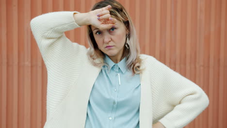 woman appearing tired or stressed outdoors