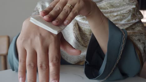 woman applying moisturizer to her hand