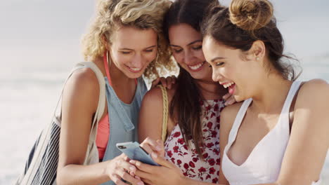 Women,-beach-and-phone-for-laugh