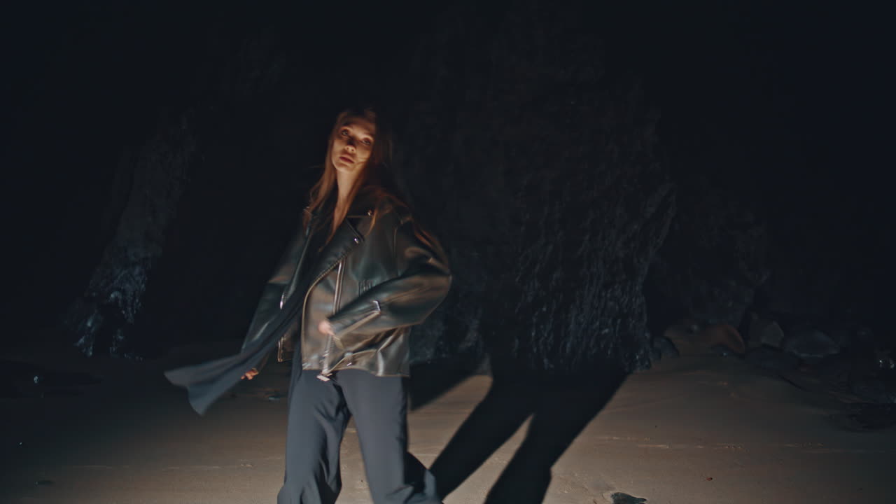 Trendy woman partying night beach looking camera. Chic girl dancing festival