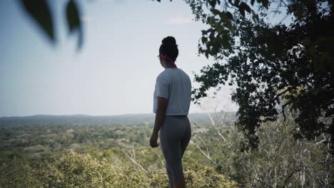 A-Female-Tourist-Looking-At-The-Beautiful-Landscape-From-The-Mountain-Hillside-In-Riviera-Maya,-Mexico