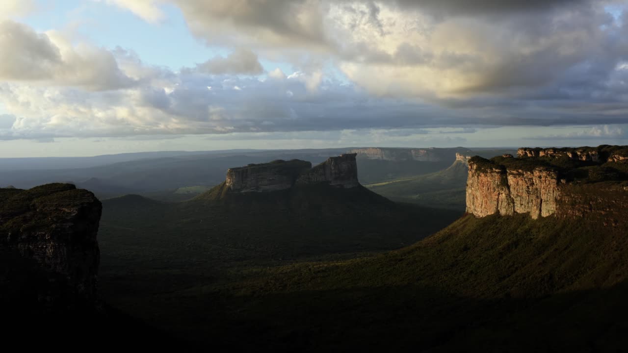 Trucking left flying drone landscape shot of the stunning Capao Valley from the Mount of Pai Inácio in the Chapada Diamantina national park in northern Brazil during golden hour