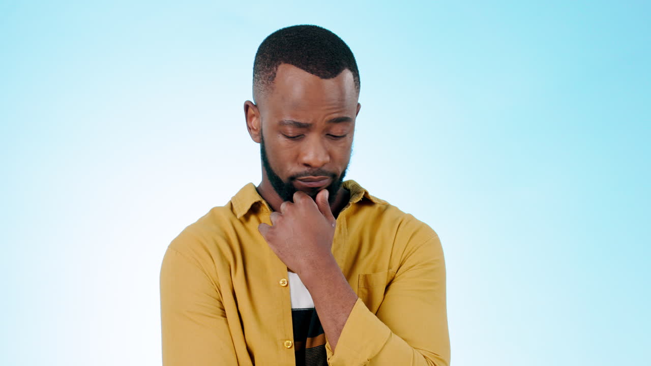 Confused, man and thinking of ideas in studio