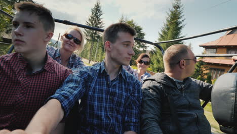 a cheerful family with children is riding an off-road vehicle off-road in the mountains active rest