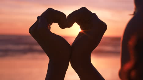 love, heart and hands of woman at beach