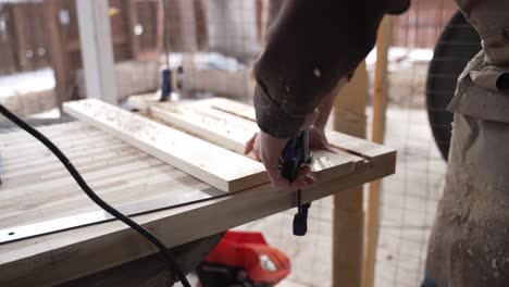 Woodworker-Using-a-Nail-Gun-on-Slabs-of-Wood