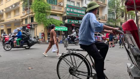 cyclo driver navigating a busy urban road