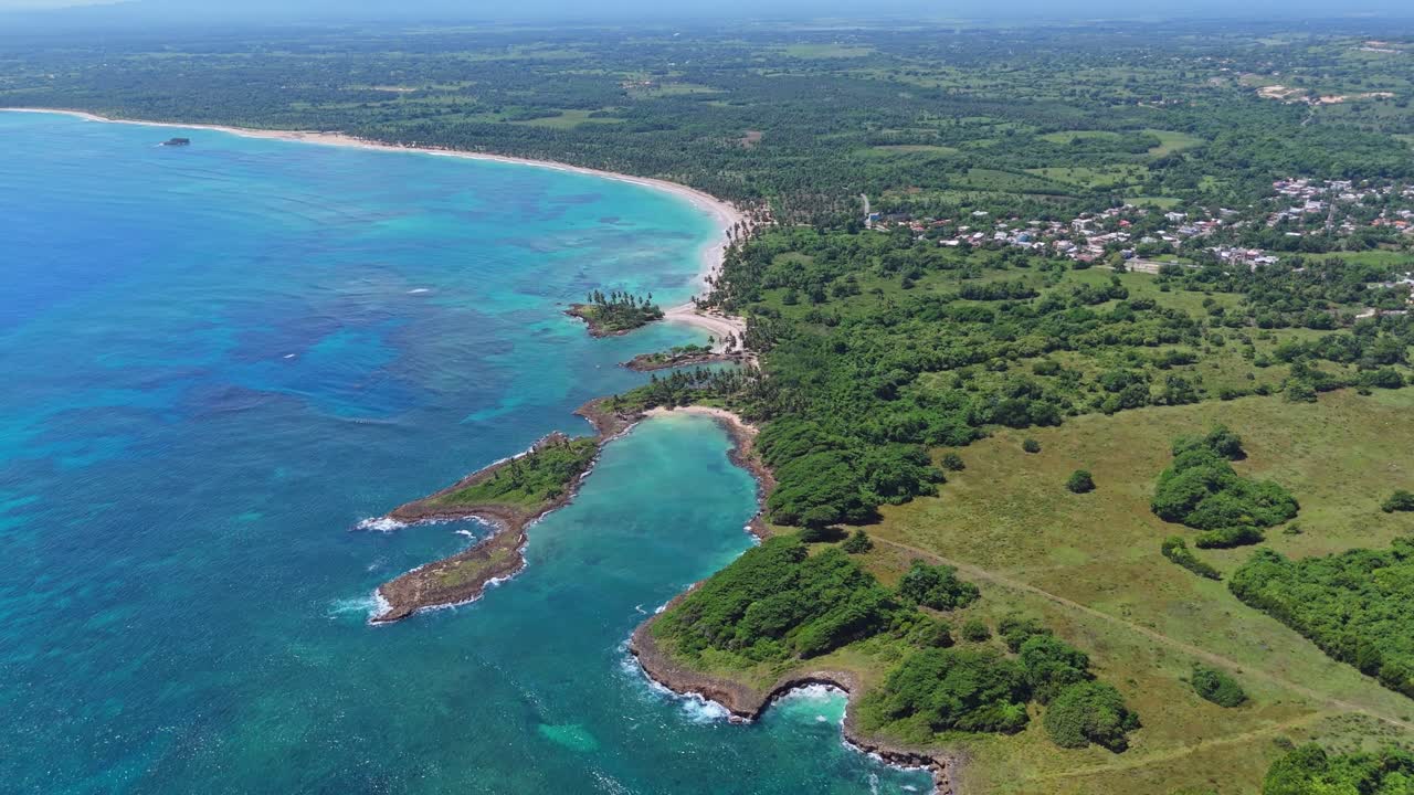 Lagoon and bay of playa Coquitos during sunny day. Beautiful coastline of tropical island and clear Caribbean Sea. Aerial Birds Eye flight.
