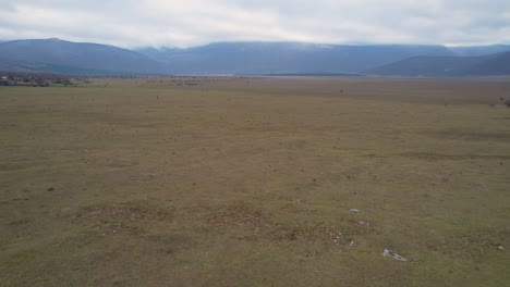 A-beautiful-landscape-drone-video-of-an-empty-countryside-field-in-Croatian-region-of-Lika-in-Croatia,-Europe